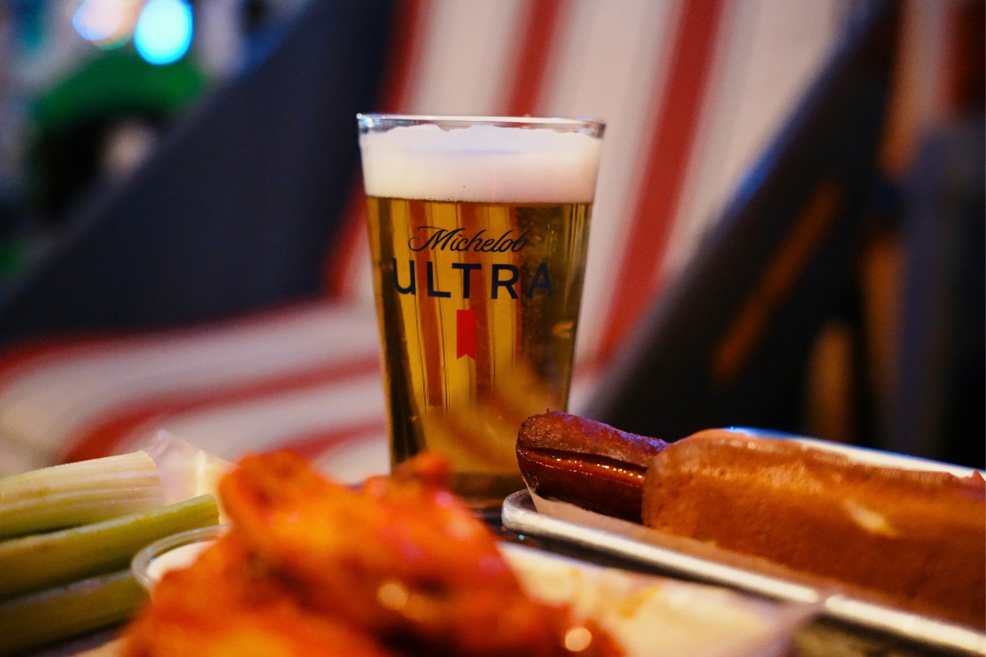 Draft beer with buffalo wings and celery during happy hour at Trailer Park After Dark San Diego