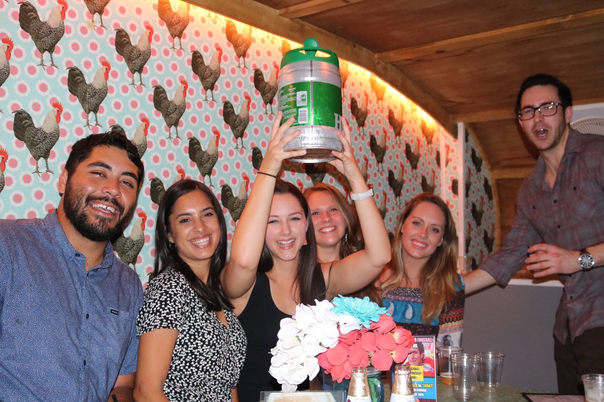 Coworkers celebrating a holiday party inside a private trailer at Trailer Park After Dark in downtown San Diego